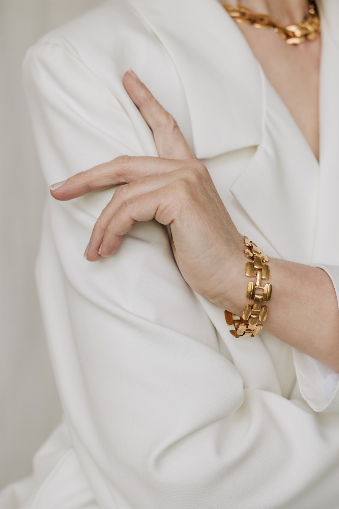 Portrait of an Elegant Woman in Gold Necklace and Bracelet